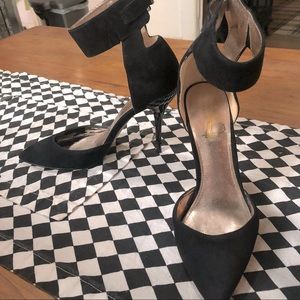 Black suede-like pumps with 4” heels and 1.5” wide ankle strap. Size 6.5